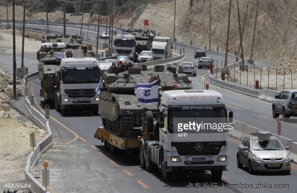452055014-israeli-lorries-transport-army-tanks-on-a-gettyimages.jpg